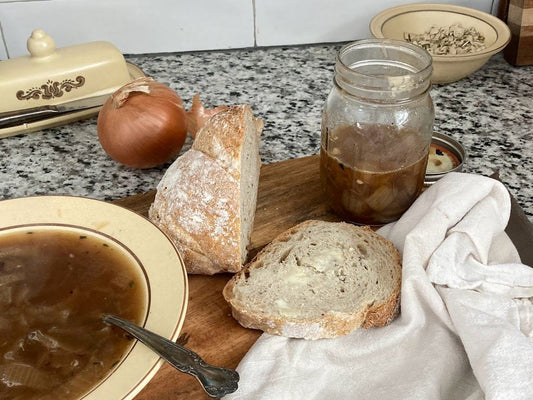 warm brothy onion soup with slice of bread