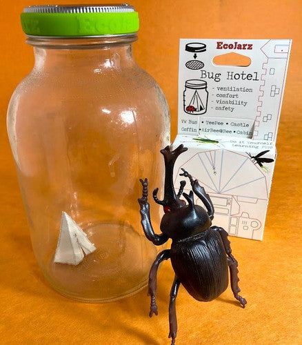 large mason jar with a paper teepee inside, next to the retail box for the Bug Hotel, and a toy beetle