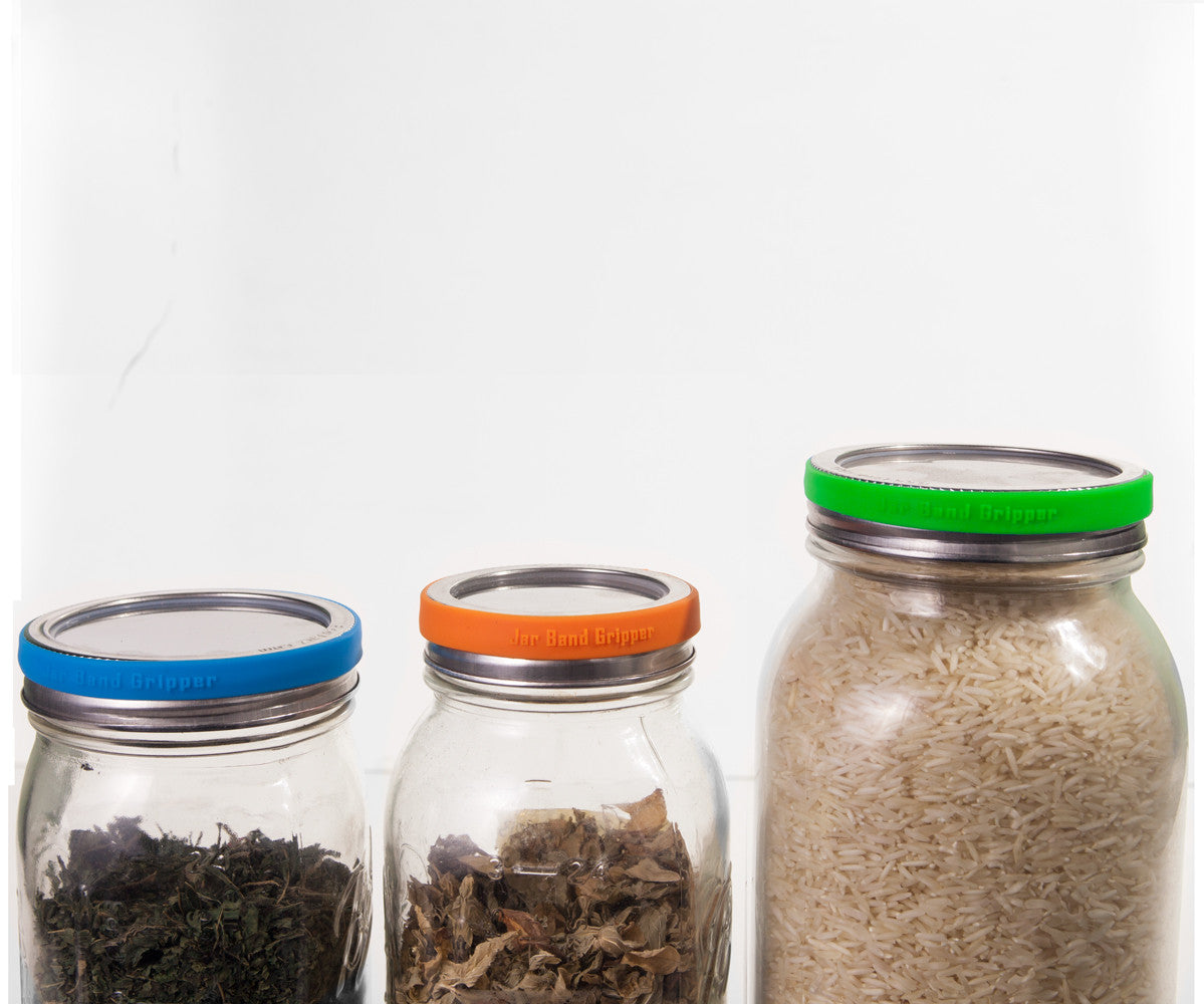 Silicone Jar Band grippers on various mason jar lids. One blue, one orange, and one green.