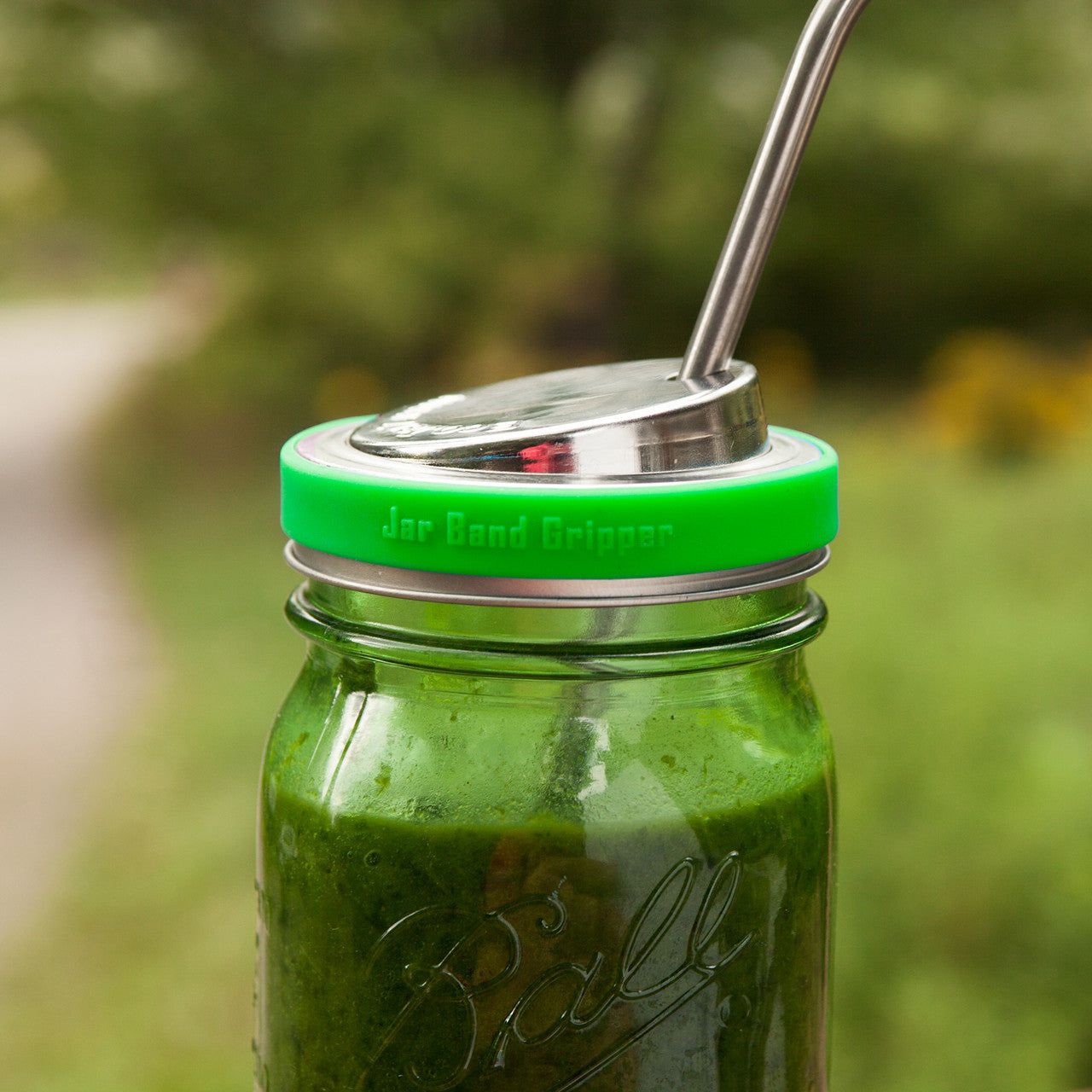 A green silicone band wrapped around a mason jar lid to add grip.