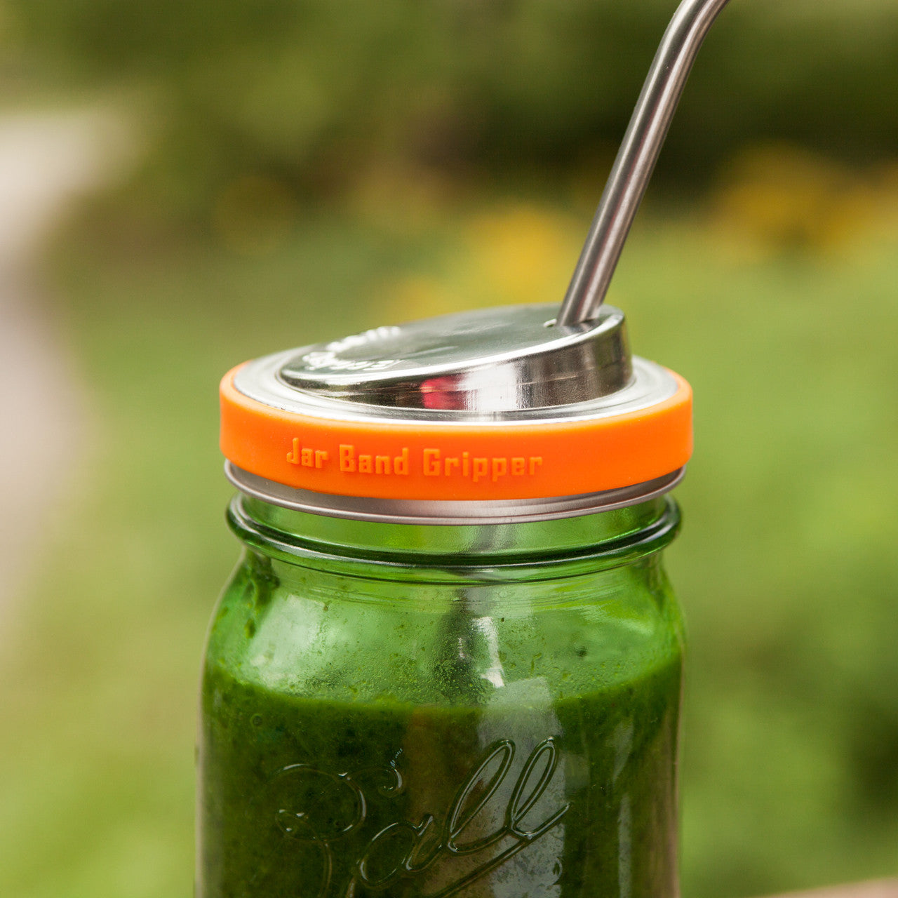An orange silicone band wrapped around a mason jar lid to add grip.