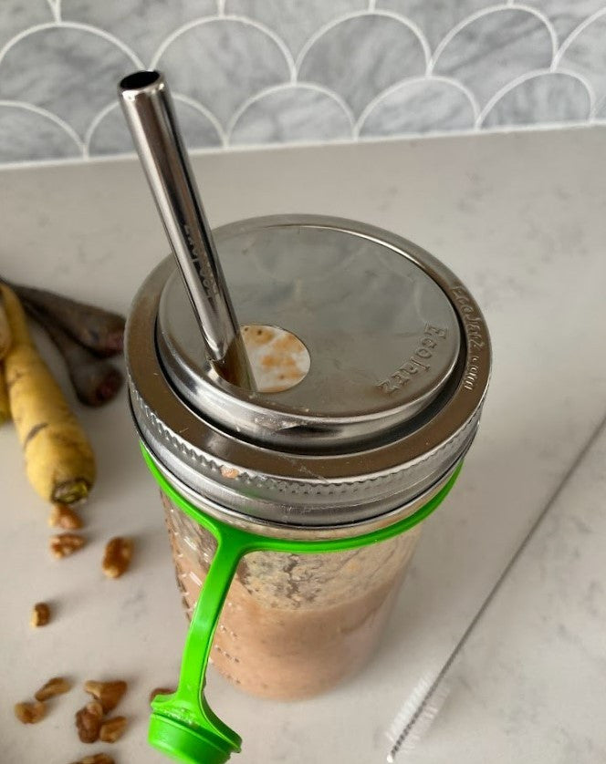 Smoothie in a 24 ounce mason jar with a poptop lid and smoothie straw.