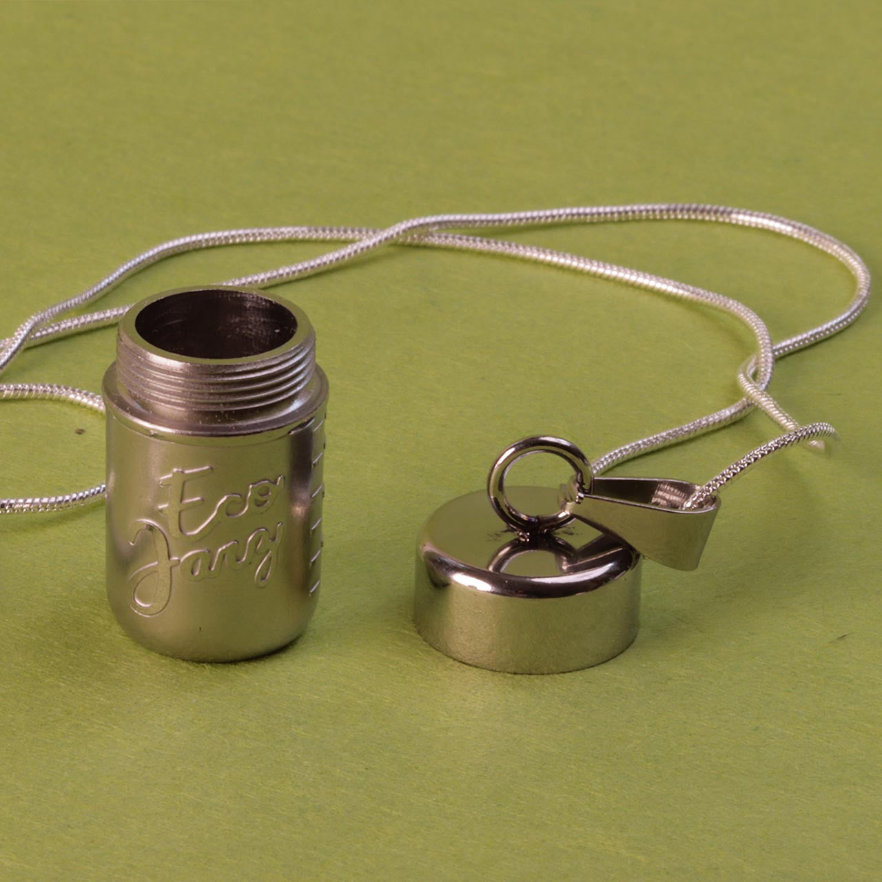 Close up of the stainless steel mason jar locket necklace with the lid off.