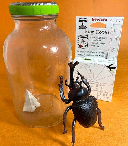 large mason jar with a paper teepee inside, next to the retail box for the Bug Hotel, and a toy beetle