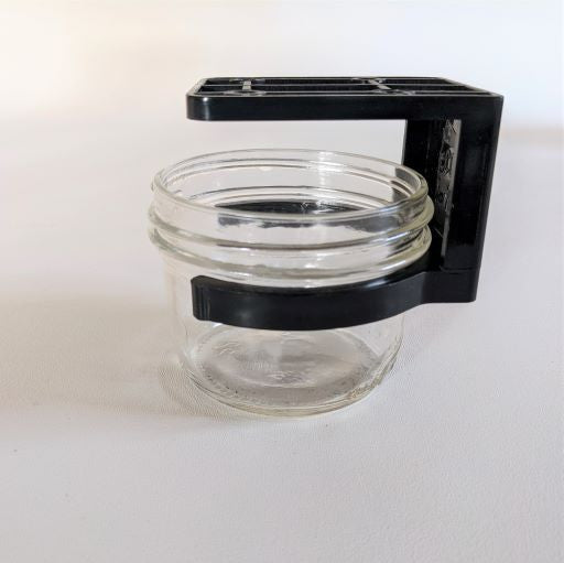 an ecojarz jar clip holding an 8 ounce wide mouth mason jar