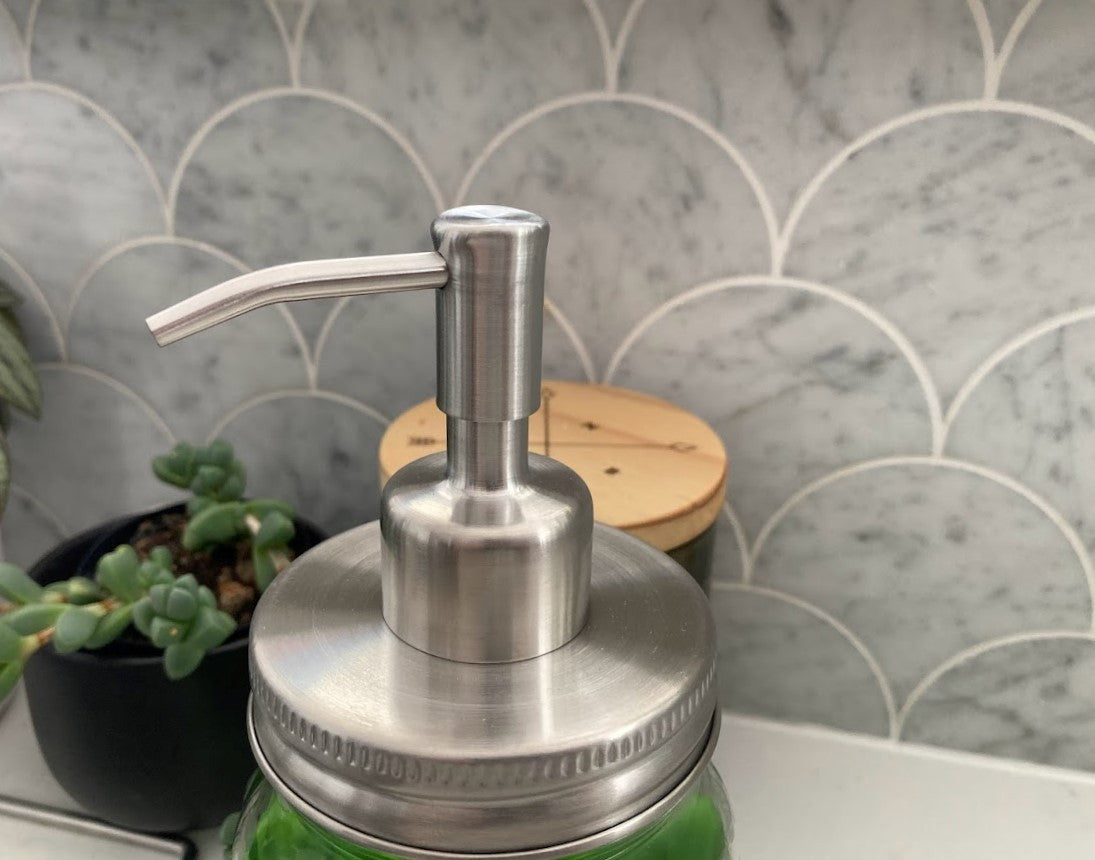 close up view of the stainless steel soap pump filled with dish soap