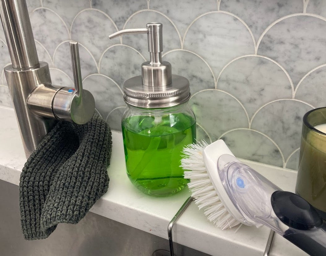 mason jar full of dish soap with the soap pump lid, next to the kitchen sink