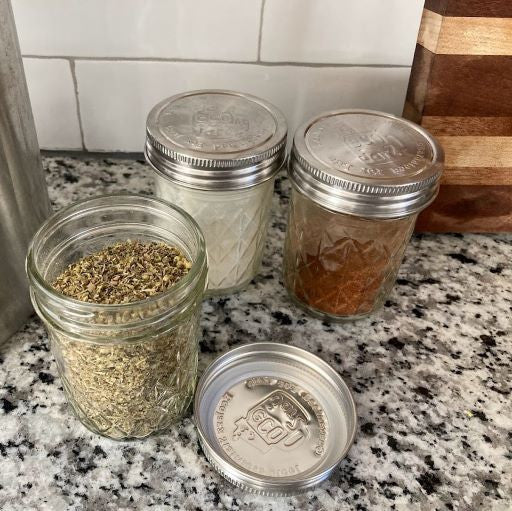 3 regular mouth mason jars full of spices with the ecojarz one piece storage lids